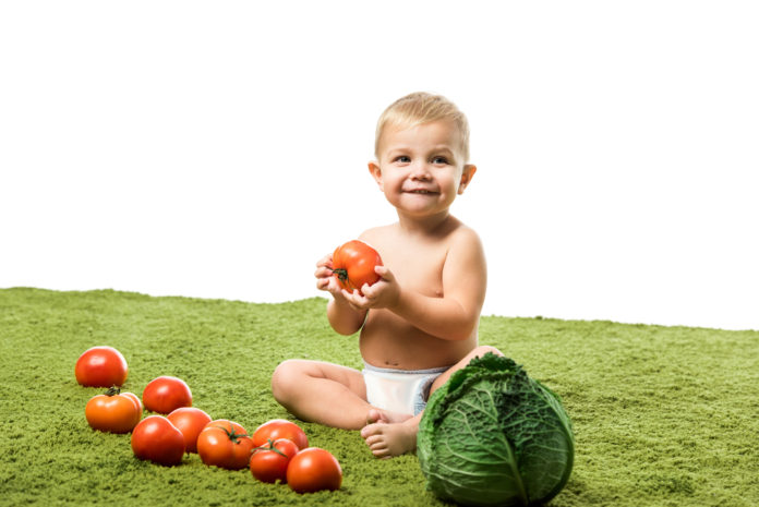 Child holding vegetables